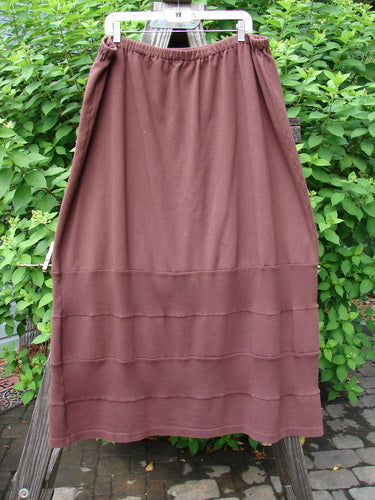 Barclay Interlock Rib Panel Skirt Unpainted Sepia Size 2, hanging on a clothesline, showcasing its horizontal ribbed panels and smooth cotton interlock texture.