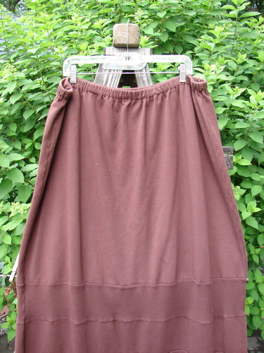 Barclay Interlock Rib Panel Skirt Unpainted Sepia Size 2 on a clothes rack, showcasing horizontal ribbed panels and smooth cotton knitting with an elastic waistline, exemplifying the BlueFishFinder's vintage, creative style.