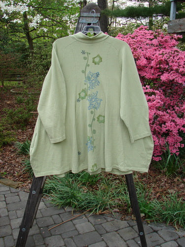 1996 Reprocessed Spring Rain Jacket Coral Reef Seedling OSFA displayed on a hanger, featuring deep side pockets, a single vintage closure, and detailed coral reef-themed accents.