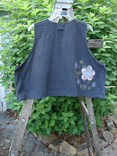 2000 Parachute Cross Stitch Vest Floral Black Size 2 displayed on a wooden ladder, showcasing its unique square neckline, four metal button closure, crop length, and vibrant floral design in perfect condition.