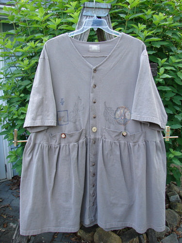 1999 Vintage Button Dress Butterfly Circle Shale Size 2 on a wooden stand, showcasing tiny front buttons, larger waist buttons, dual draw cords, two high pockets, and a butterfly theme design, exemplifying Bluefishfinder's unique vintage style.