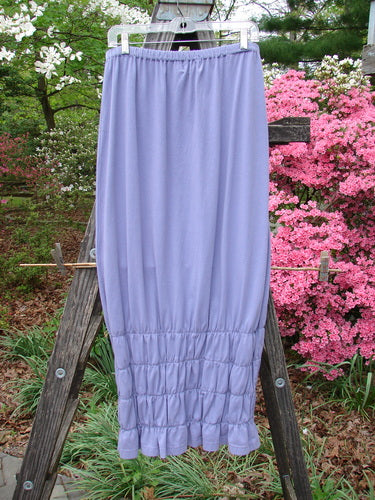 2000 Rings of Saturn Skirt Unpainted Twilight Size 2 displayed on a wooden ladder; features an elastic waistline and detailed stretchy smocking, perfect for pairing with other summer pieces.