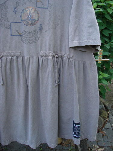 1999 Vintage Button Dress Butterfly Circle Shale Size 2, featuring intricate butterfly-themed paint, 11 buttons down the front, larger buttons at the waist, dual rear draw cords, and higher placed pockets.