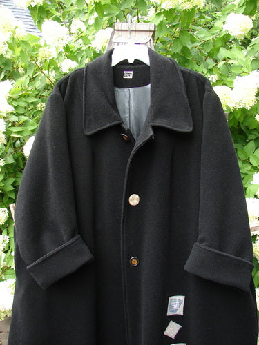 1999 Patched Woven Overcoat Black Size 2: Vintage-inspired fully lined overcoat with hand-blacked patches. Features include oversized button front, deep inseam wool-lined pockets, and a swinging A-line shape. Bust 60, Waist 64, Hips 66, Sweep 90, Length 52 inches.