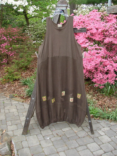 2000 Cotton Hemp Libby Jumper Leaf Flower Bark Size 2, displayed on a wooden rack. Features a downward scooped waistline, two side pockets, and a lower bubbled shape with leaf and flower paint accents.