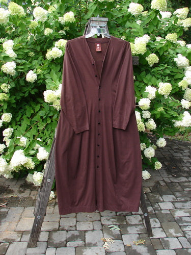 1998 Merino Pria Dress Unpainted Raisin Size 1 displayed on a standing mannequin, with detailed vertical seams, ribbed round neckline, and shiny diamond-cut buttons, showcasing the dress's hourglass shape and unique design features.