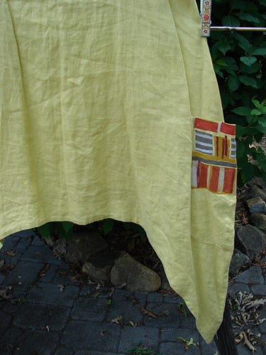 Barclay Linen Single Side Pocket Pinafore Geos Sunshine Size 1 features an A-line flair, scoop neckline, and painted pocket, showcasing BlueFishFinder's signature vintage-inspired creative freedom.