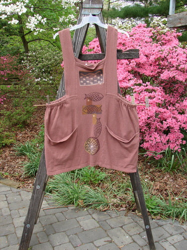 1995 Reprocessed Cottage Jumper Sea of Fish Clove Size 3 displayed on a wooden ladder, showcasing thick shoulder straps, sectional bib, elastic sides, and two large front pockets.