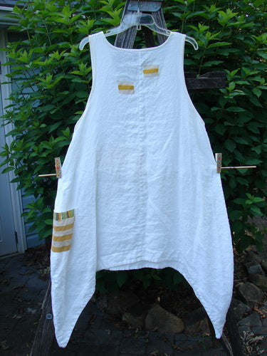 Barclay Linen Single Side Pocket Pinafore Geos White Size 1 hanging on a clothesline, showcasing its sweeping A-line flair and distinctive exterior painted pocket, embodying Bluefishfinder.com's vintage, creative fashion ethos.