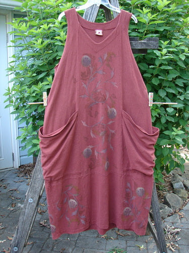 Barclay Cotton Hemp Double Drop Pocket Jumper in Cinnabar, featuring a slightly square V neckline, oversized angular wrap pockets, banded hemline, and a generous curl vine pattern, showcased outdoors.