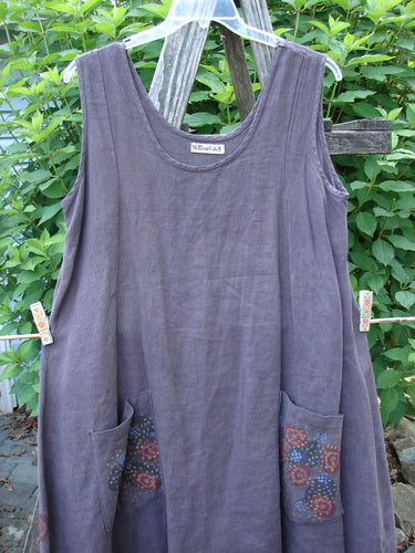 Barclay Linen Pocket Pinafore Polka Dot Plum Oversized Size 0 hanging on a clothesline, showcasing its A-line flair, scoop neckline, and distinctive polka dot exterior painted pockets.