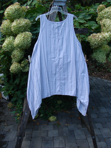 Barclay NWT Percale Hado Shift Stripe Smoke Pearl Size 1 tunic hangs on an easel, showcasing its loose fit, deep scoop neckline, and A-line shape with varying hem and pinstripes.