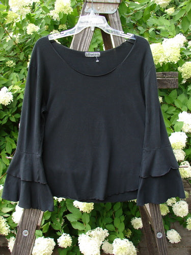 Barclay Cotton Lycra Long Sleeved Petal Top Unpainted Black Size 0 displayed on a swinger, showcasing a rounded raw neckline and fluttered lowers, with exterior curly stitchery in an A-line shape.