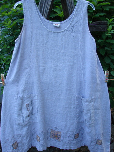 Barclay Linen Pocket Pinafore Mosaic Floral Lavender Size 0, displayed outdoors, featuring sectional panels, A-line flair, and double drop exterior painted pockets with a mosaic floral theme, capturing Bluefishfinder.com's vintage, expressive style.