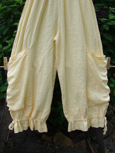 Barclay Linen Tie Bottom Pocket Bloomer Buttercup Size 1 displayed on a clothesline, showcasing its full elastic waist, two front pockets, and blooming lowers with pull ties, perfect for mixing and matching.