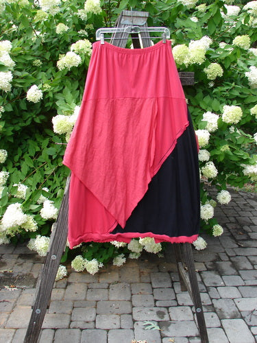 Barclay NWT Mixed Media Swatch Skirt Unpainted Black Rose Size 2, displayed on a rack, featuring layered panels, elastic waistline, and contrasting textures.
