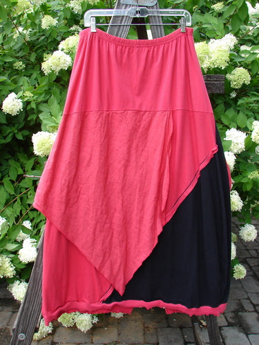 Barclay NWT Mixed Media Swatch Skirt Unpainted Black Rose Size 2 displayed on a clothes rack, featuring layered textures and directional swatches, highlighting its unique design and dimensional elements.