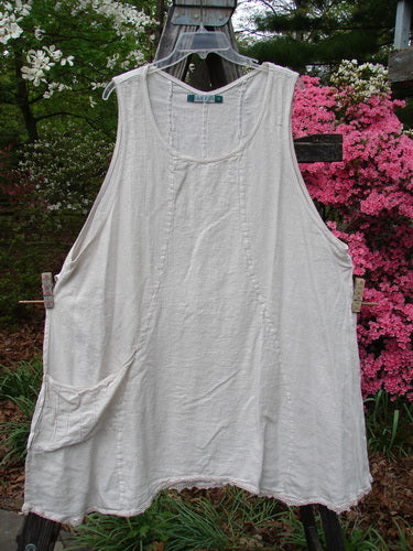 Barclay Slub High Vent Figure 8 Lace Pocket Pinafore Dress Unpainted Crème Size 2 hanging on a clothesline, showcasing its unique figure-eight seams, lacy hem accents, and A-line shape.