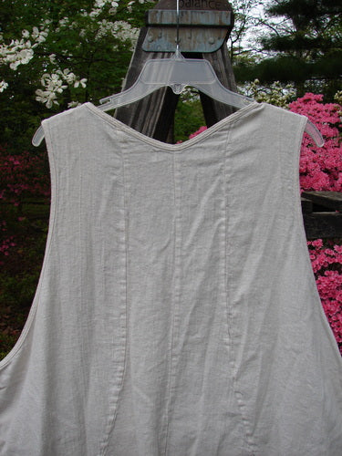 Barclay Slub High Vent Figure 8 Lace Pocket Pinafore Dress Unpainted Crème Size 2 displayed on a swing, showcasing its unique figure-eight seams, drop side pockets, and lacy hem accents.