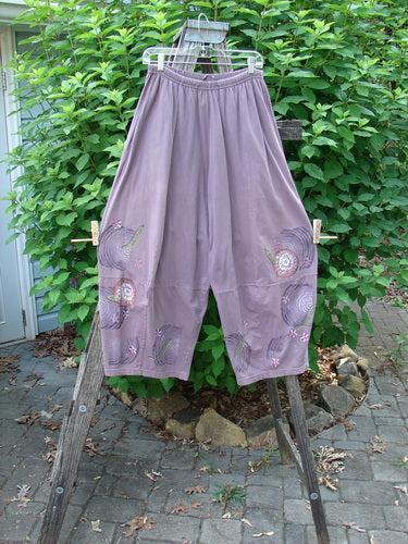 Barclay 4 Square Pant Spin Wind Dusty Plum Size 0 displayed on a wooden ladder, showcasing its unique 3D diamond drape from the knee down and full elastic waistband.