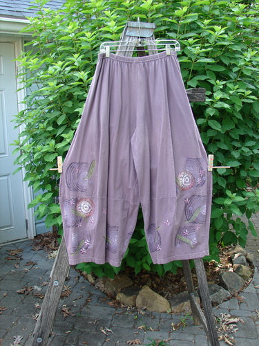 Barclay 4 Square Pant Spin Wind Dusty Plum Size 0, shown hanging outside, features a 3D diamond drape from knee down, with an elastic waistband and pockets, highlighting its unique design and movement.