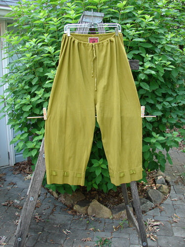 Barclay Bow Bottom Pantaloon Unpainted Green Olive Size 0 displayed on a clothesline, featuring a full elastic waist with draw cord, gathered cuffs, and textured ribbon bows.
