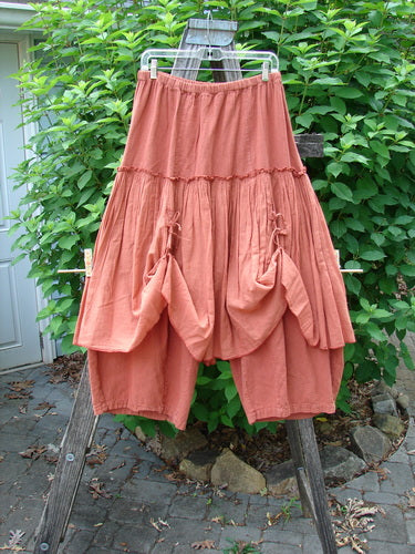 Barclay Hemp Linen Batiste Fusion Pant Skirt Autumn Harvest Size 0 displayed with its full elastic waistline, triangular patch ties, and layered design on a clothes rack.