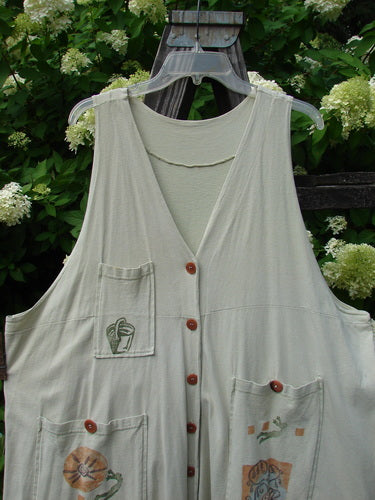 1994 Fishing Vest Magic Garden Aloe OSFA: A white vest with buttons on a swinger, featuring a great A-line shape, three front painted pockets, and a deep V-shaped neckline.