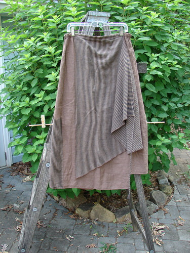 Barclay Linen Every Way Apron Skirt Stripe Mocha Size 0 displayed outdoors, showcasing its full elastic waistline, striped side layer apron, sectional stripe panels, and unique exterior stitchery.