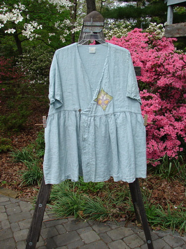 1999 Linen Adjustable Wrap Dress Butterfly Water OSFA displayed on a hanger, featuring a cross-over front, empire waistline, flouncy skirt, and butterfly print center wrap.