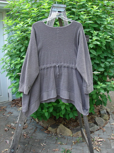 Barclay Patched Crepe Perennial Tunic Top Woods Bark Size 1 displayed on a clothes rack, showcasing its textured stretch cotton crepe, empire waist seam, and front drop wrap side pockets.