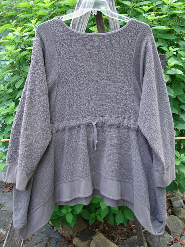 Barclay Patched Crepe Perennial Tunic Top Woods Bark Size 1 on a clothes rack, showcasing its textured cotton crepe fabric, unique S-shaped seams, and oversized patches, epitomizing Bluefishfinder.com's vintage creative fashion.