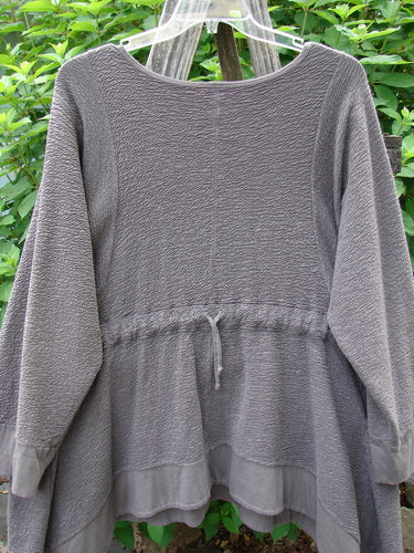 Barclay Patched Crepe Perennial Tunic Top Woods Bark Size 1 displayed on a rack, showcasing its textured stretch cotton crepe fabric, downward curved empire waist, and oversized patches.