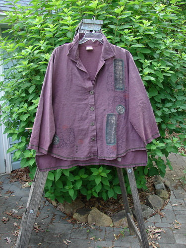 Barclay Hemp Cotton Metal Button Workshirt in Plum Wine displayed on a swinger, showcasing its metal buttons, contrasting stitchery, and Asian script design.