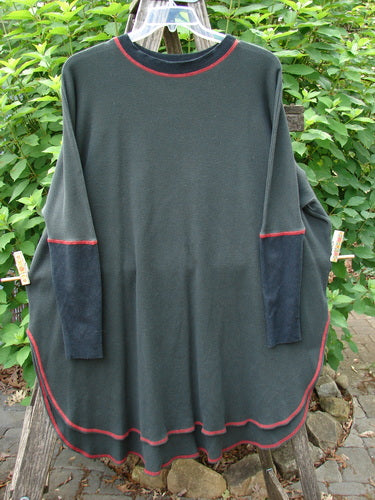 Barclay Thermal Contrast Revival Top Unpainted Black OSFA featuring ribbed sleeves, a rounded neckline, and an A-line shape with side vents, hanging on a clothes rack.