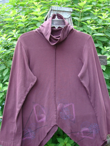 Barclay Cotton Lycra Symmetrical Turtleneck Top Galaxy Deep Burgundy Size 0: A beautifully flowing top with a mock turtleneck, varying hemline, vertical stitching, and long cozy sleeves.