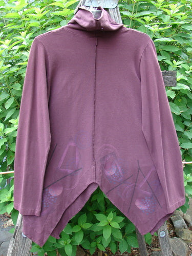 Barclay Cotton Lycra Symmetrical Turtleneck Top Galaxy Deep Burgundy Size 0, featuring a unique asymmetrical hemline, vertical exterior stitching, and long sleeves, visually characterized by its turtleneck and flowing design.