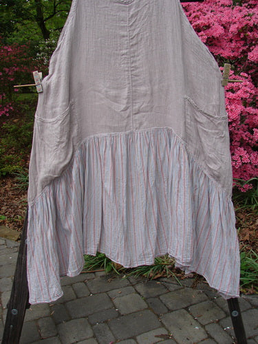 Barclay Gauze Batiste Peasant Jumper Unpainted Stripe Mallow Size 2 hanging on a clothesline, showcasing its full cotton gauze upper, batiste stripe lower, scooped neckline, and exterior wrap pockets.