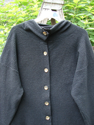 Barclay Crepe Mock Collar Jacket Unpainted Black Size 0 features a textured stretch crepe fabric, mock neckline, wide sleeves, and drop shoulders, reflecting BlueFishFinder's ethos of individuality and vintage style.