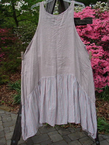 Barclay Gauze Batiste Peasant Jumper Unpainted Stripe Mallow Size 2 hanging on a clothesline, showcasing its full cotton gauze upper, batiste stripe lower, and exterior wrap pockets.
