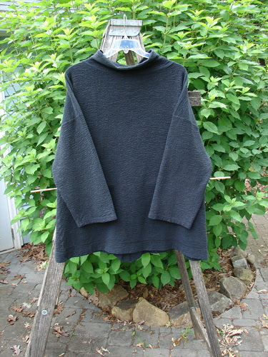 Barclay Crepe Mock Collar Jacket Unpainted Black Size 0 on a clothes rack, showcasing textured stretch crepe fabric, long wide sleeves, mock neckline, and drop shoulders, reflecting Bluefishfinder.com's vintage style.