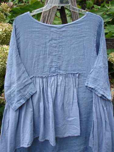 Barclay NWT Gauze Batiste Petal Urchin Flounce Dress in Dusty Sky, size 1, features a loose-fitting design with a scooped neckline, three-quarter sleeves, and a flowing hem, ideal for expressing individuality.