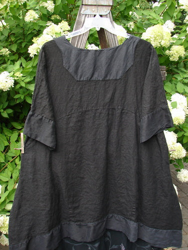 Black Barclay Linen Crossover Two Tier Dress on a hanger, highlighting its V neckline, double-layered flow, wide cuffs, and floral theme, showcasing the unique, vintage style from BlueFishFinder.com.