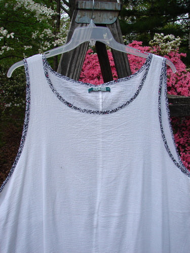 Barclay Crinkle Gauze Contrast Ditsy Daisy Pinafore Unpainted White Size 2 displayed on a plastic swing, featuring a scoop neckline and floral hem accents.