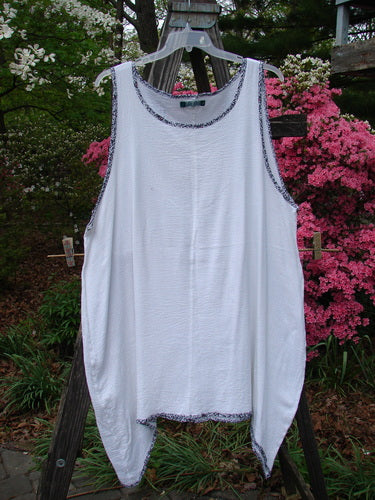 Barclay Crinkle Gauze Contrast Ditsy Daisy Pinafore Unpainted White Size 2 displayed on a clothes rack, showcasing its scoop neckline, deeper arm openings, and full hem with floral print.