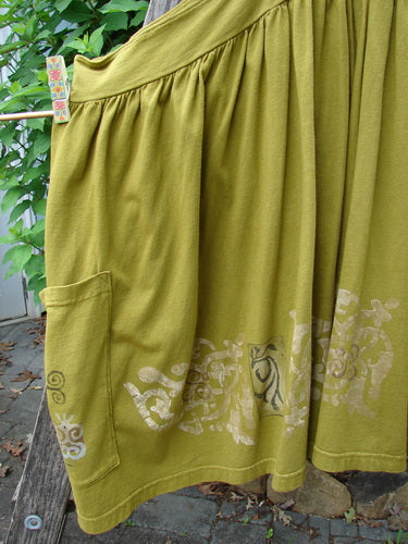 Barclay Overall Jumper Celtic Sun Glazed Tile OSFA features a creatively cut bib, crisscross straps, a wide skirt, and oversized pockets, embodying Bluefishfinder.com's vintage, expressive style.