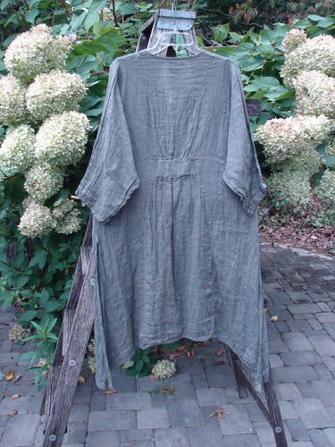 Barclay NWT Linen High Vent Venetian Dress Farm Dark Caper Size 1 displayed on a wooden ladder with wide sleeves and gathered waist, surrounded by creamy-white hydrangeas, highlighting its elegant, flowing design.