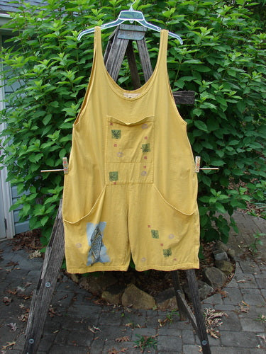 1991 Farmer Brown Overall Pant Jumper Vintage Fish Goldenrod OSFA displayed on a clothesline, featuring generous straps, front dual pocket, painted rear tab, and extra lower leg panel, embodying unique vintage style.