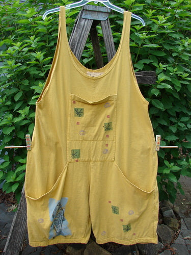 1991 Farmer Brown Overall Pant Jumper Vintage Fish Goldenrod OSFA hanging on a clothesline, showcasing its generous shoulder straps, dual-stacked front pocket, and signature Blue Fish patch, embodying BlueFishFinder's vintage style.