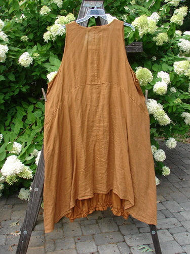 Barclay Linen Open Front Drawcord Hem Jumper Garden Squash Size 2: A brown dress with a layered cross over front apron and batiste under skirt. Features include a downward curved empire waist seam, deeper oval neckline, and sectional rear panels.